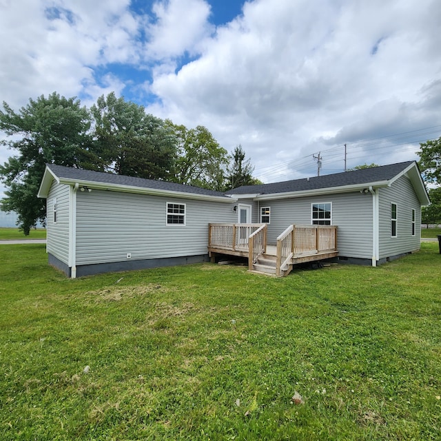 rear view of house with a yard and a wooden deck