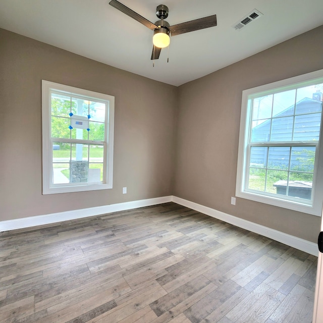 unfurnished room featuring ceiling fan and hardwood / wood-style floors