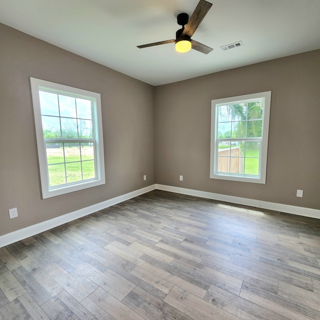 spare room with ceiling fan and hardwood / wood-style flooring