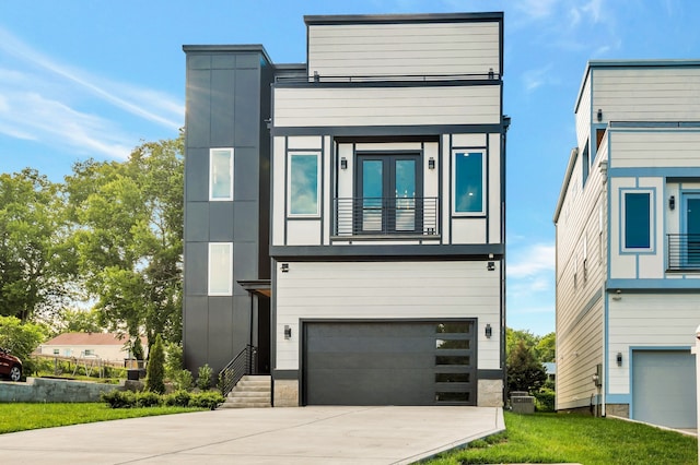 contemporary home with a garage and a balcony