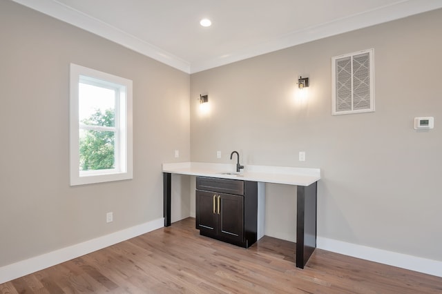 bathroom with hardwood / wood-style flooring, crown molding, and vanity