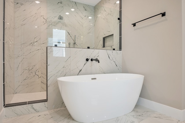 bathroom featuring tile flooring, tile walls, and separate shower and tub