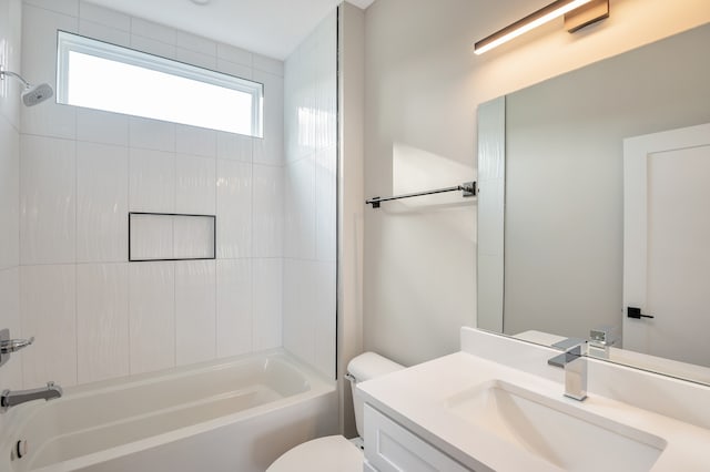 full bathroom featuring tiled shower / bath combo, vanity, and toilet