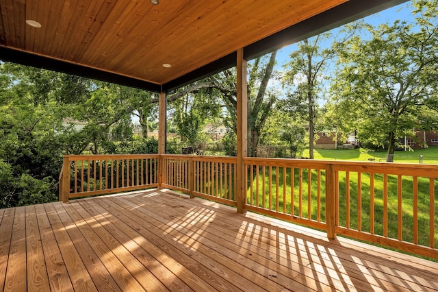 wooden terrace featuring a yard