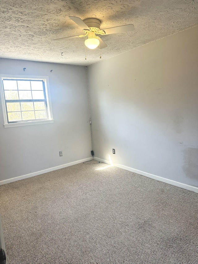 carpeted empty room featuring a textured ceiling and ceiling fan