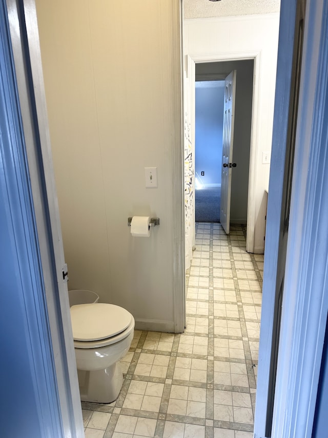 bathroom with tile patterned floors and toilet