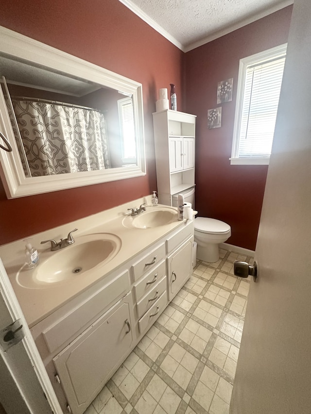 bathroom featuring vanity, a textured ceiling, and toilet