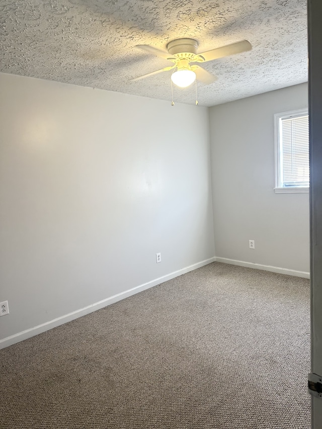 carpeted empty room with a textured ceiling and ceiling fan