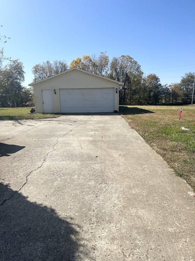 garage featuring a lawn