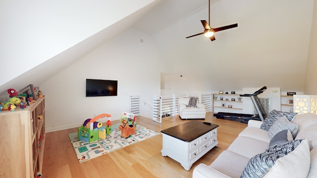 living room featuring high vaulted ceiling, light hardwood / wood-style floors, and ceiling fan