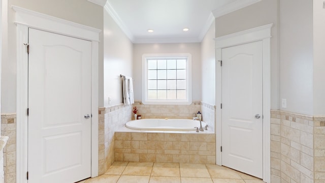 bathroom featuring crown molding, tiled tub, and tile flooring