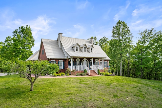 new england style home featuring a porch and a front lawn