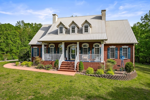 cape cod house featuring a porch and a front lawn