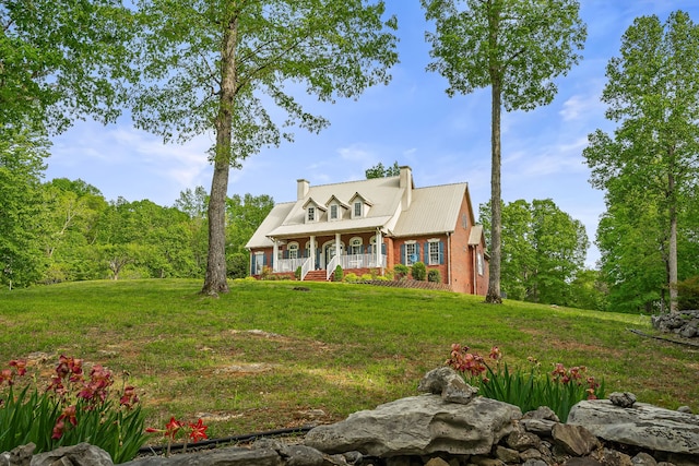 new england style home featuring a porch and a front lawn