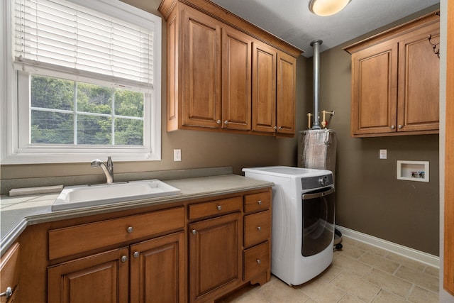 washroom with cabinets, light tile patterned floors, washer / dryer, and sink