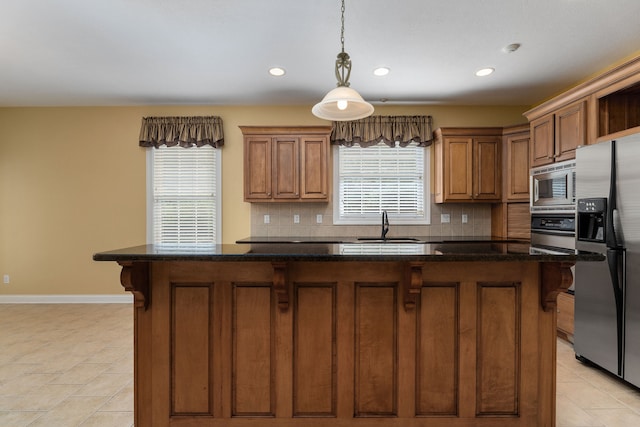 kitchen with light tile patterned floors, a healthy amount of sunlight, decorative backsplash, and stainless steel appliances