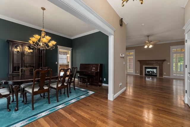 dining room featuring a high end fireplace, dark hardwood / wood-style floors, and ornamental molding