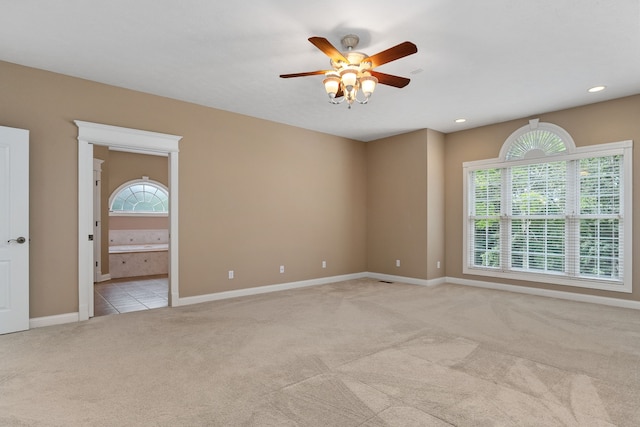 carpeted empty room featuring ceiling fan