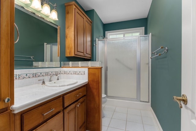 bathroom featuring vanity, toilet, tile patterned floors, and an enclosed shower