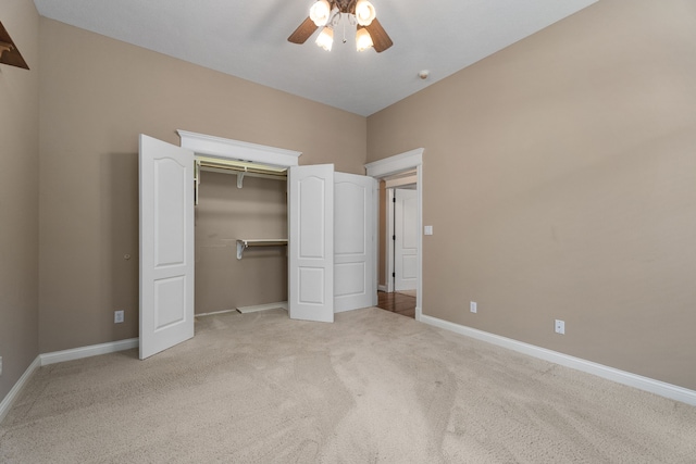 unfurnished bedroom featuring light carpet, a closet, and ceiling fan