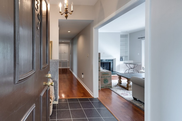 entryway featuring dark tile flooring