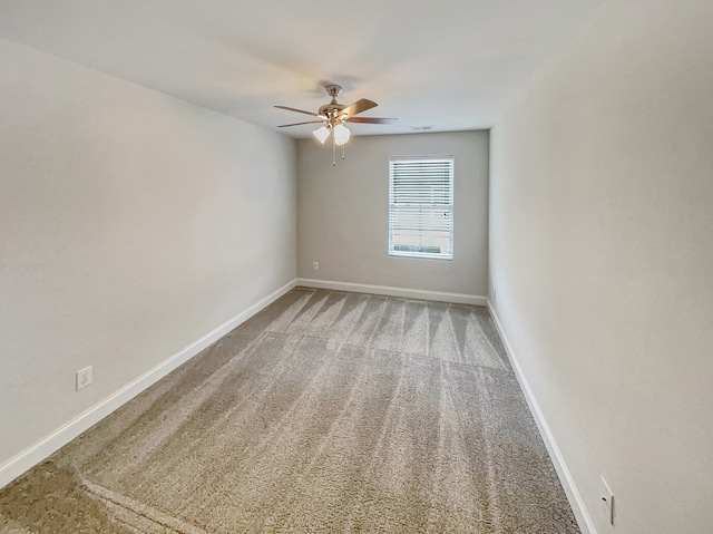 carpeted empty room featuring ceiling fan