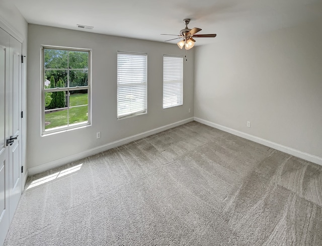 carpeted empty room featuring ceiling fan