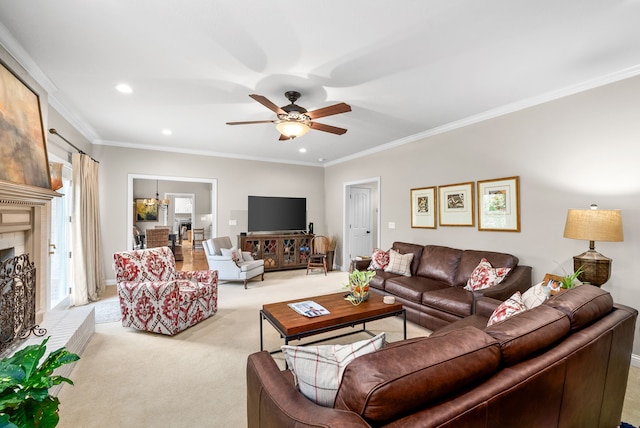 carpeted living room featuring a fireplace, ceiling fan, and ornamental molding