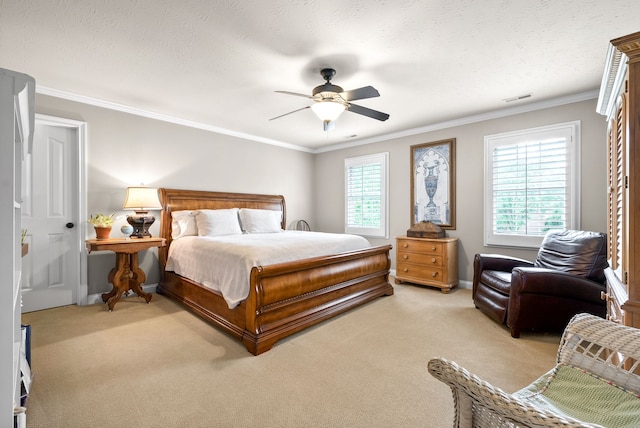 carpeted bedroom with ornamental molding, ceiling fan, and a textured ceiling