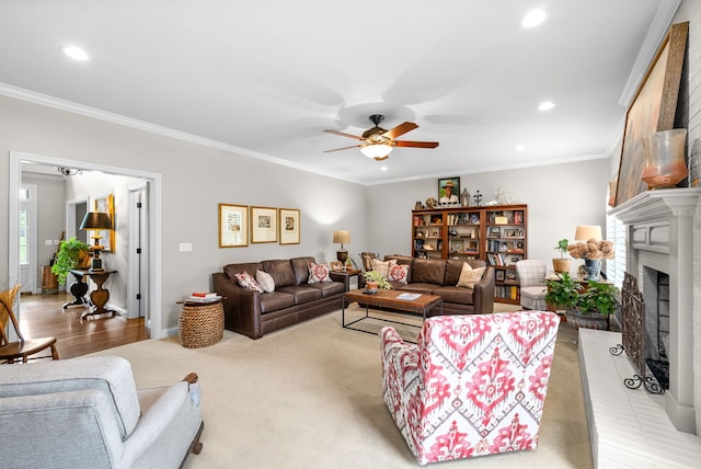 carpeted living room with crown molding, a brick fireplace, and ceiling fan