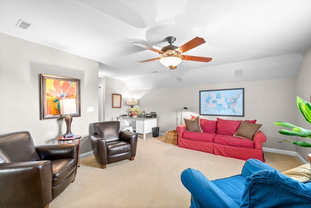 living room with ceiling fan, carpet floors, and lofted ceiling