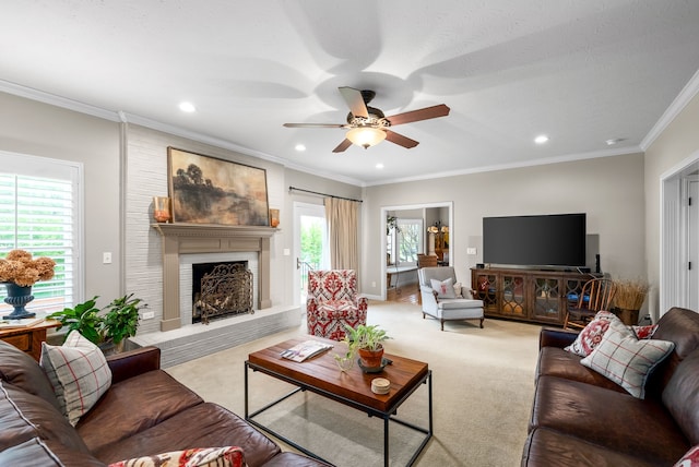 carpeted living room featuring ornamental molding, a healthy amount of sunlight, a brick fireplace, and ceiling fan