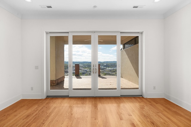 doorway featuring light hardwood / wood-style floors and crown molding