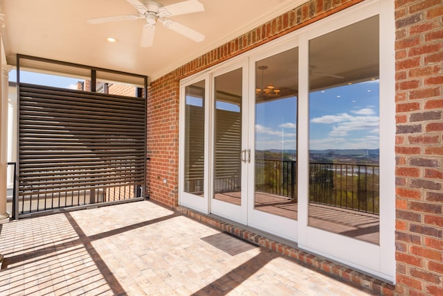 unfurnished sunroom with ceiling fan