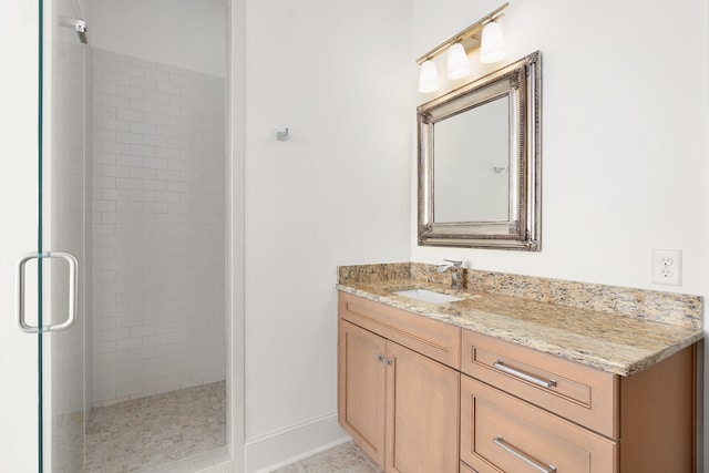 bathroom featuring tile patterned flooring, vanity, and a shower with door