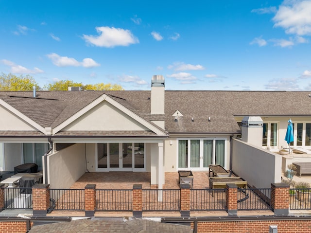 rear view of property featuring a patio and french doors