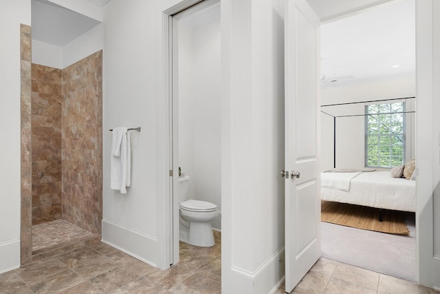 bathroom with tiled shower and toilet