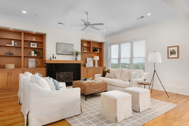 living room featuring light wood-type flooring and ceiling fan