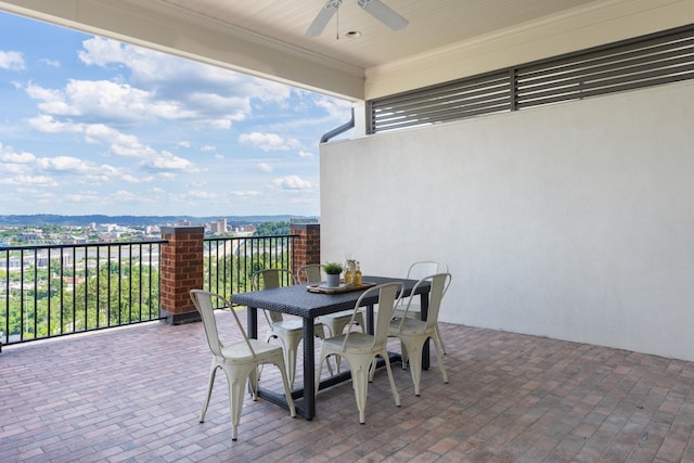 view of patio featuring a mountain view, a balcony, and ceiling fan