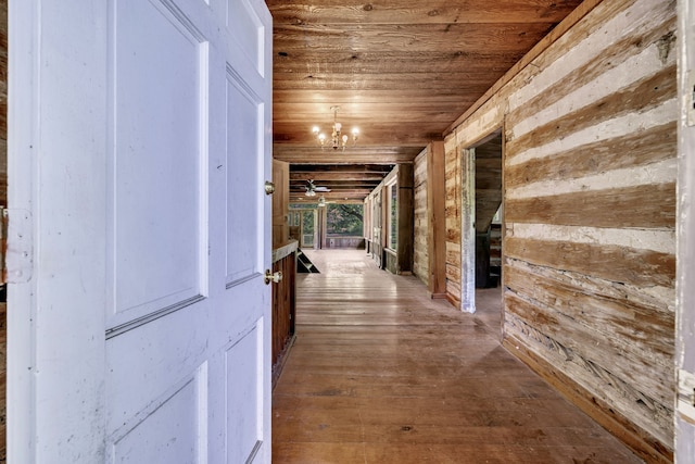 hall featuring wooden ceiling, hardwood / wood-style floors, and a notable chandelier