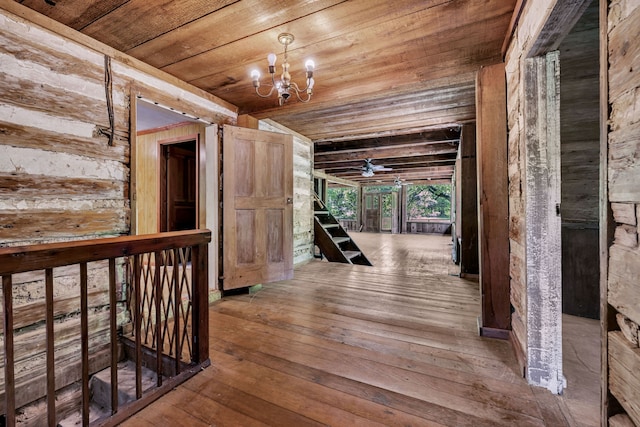 hall featuring wood-type flooring, an inviting chandelier, and wooden ceiling