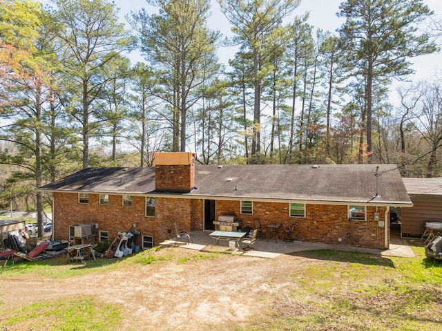 rear view of property featuring a patio area