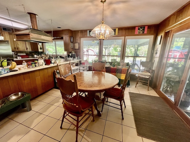 tiled dining room featuring a chandelier