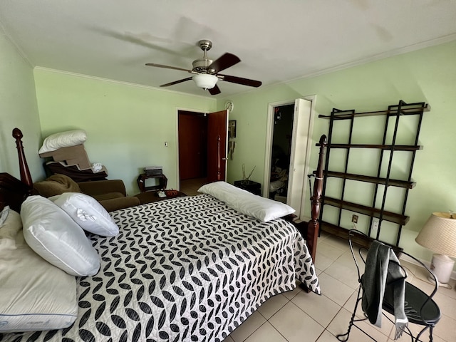 tiled bedroom with ornamental molding and ceiling fan