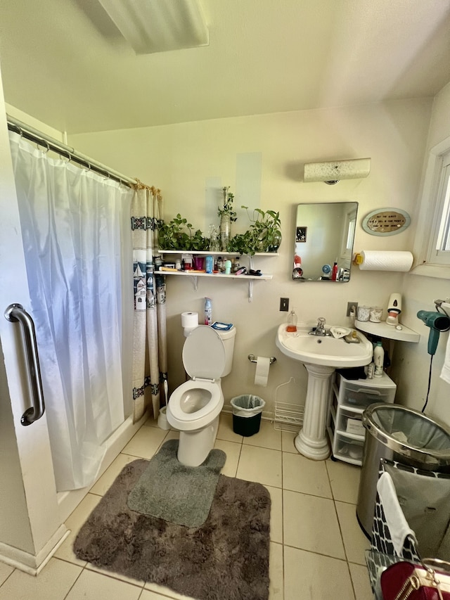 bathroom featuring toilet and tile flooring