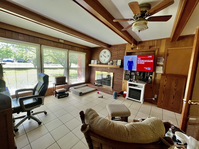 living room with a wealth of natural light, a brick fireplace, beamed ceiling, and light tile flooring