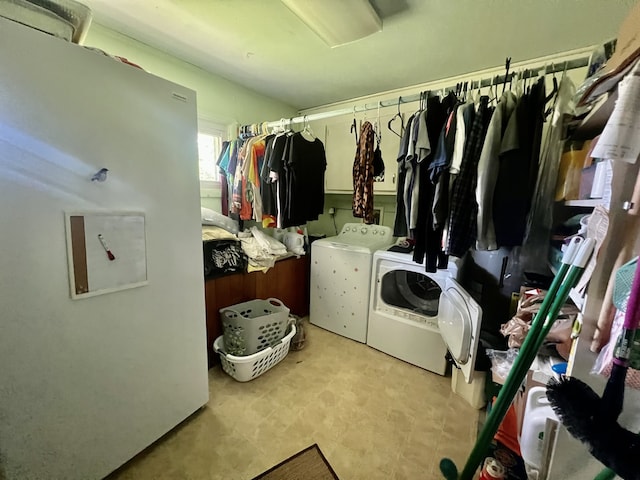 washroom with cabinets, light tile floors, and washer and dryer