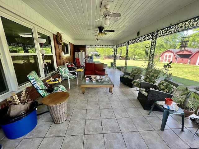 sunroom featuring ceiling fan and wood ceiling