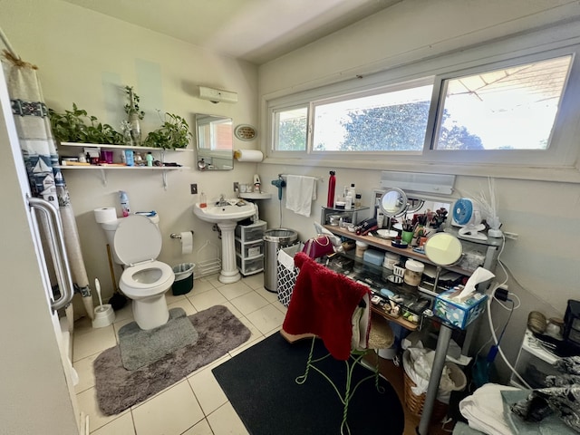 bathroom featuring toilet and tile flooring