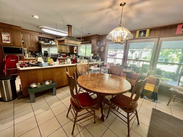 tiled dining space with a notable chandelier